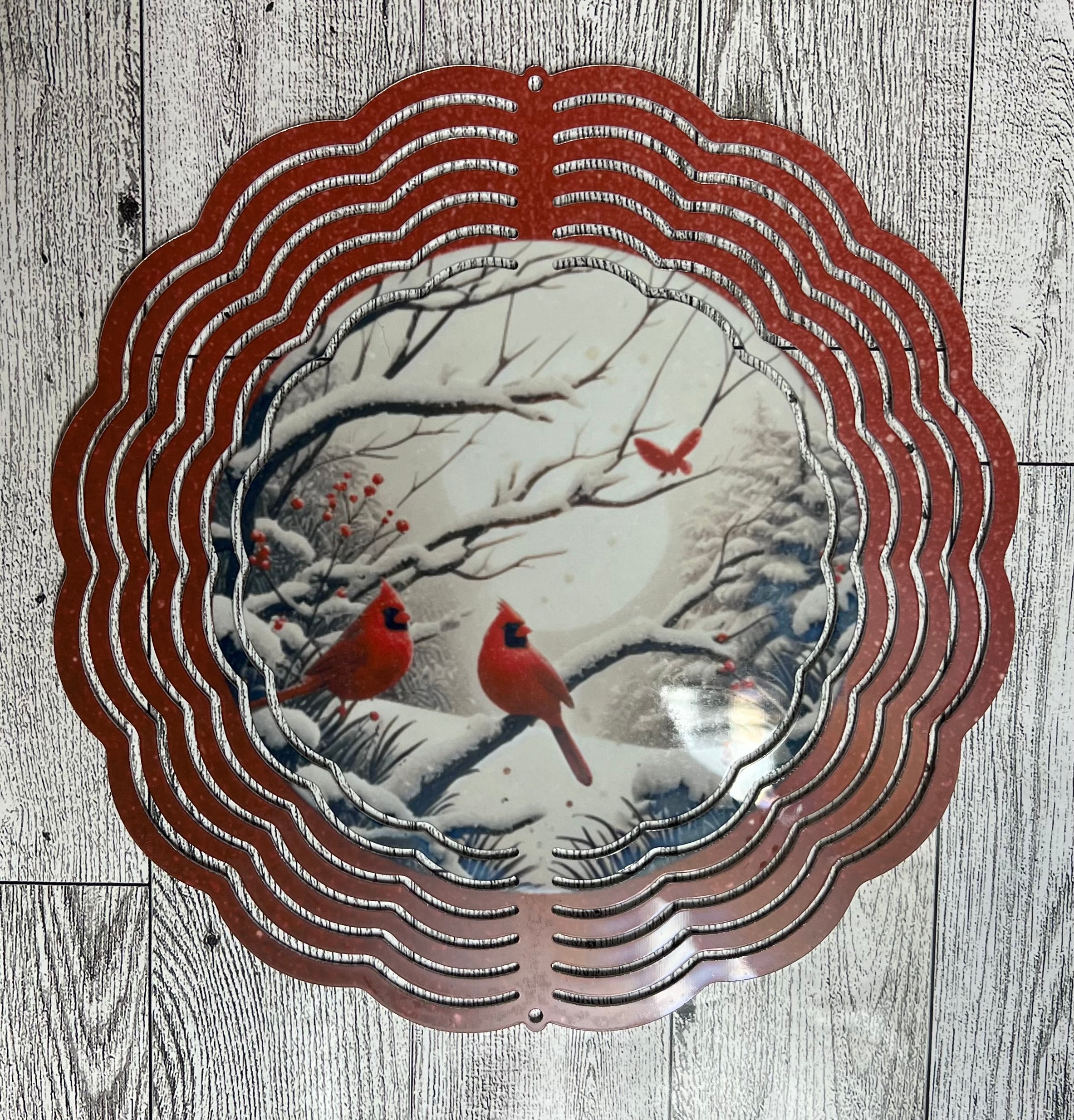 Wind Spinner Cardinals in snowy tree